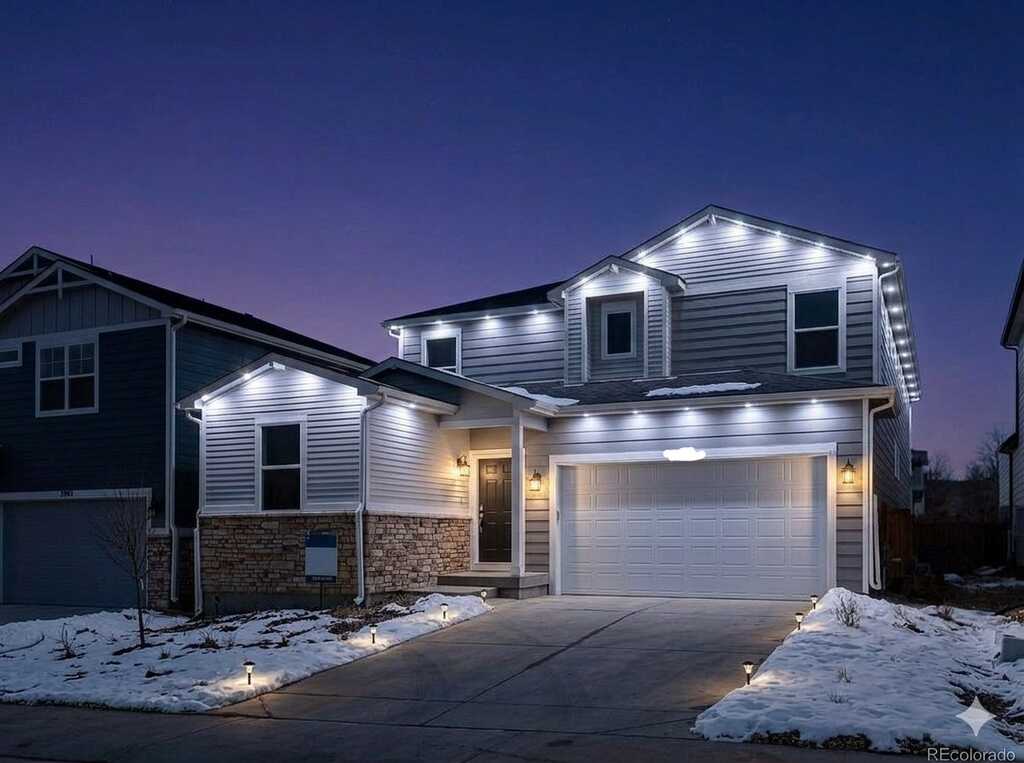 Warm white permanent exterior lighting installed on a Kansas City metro home